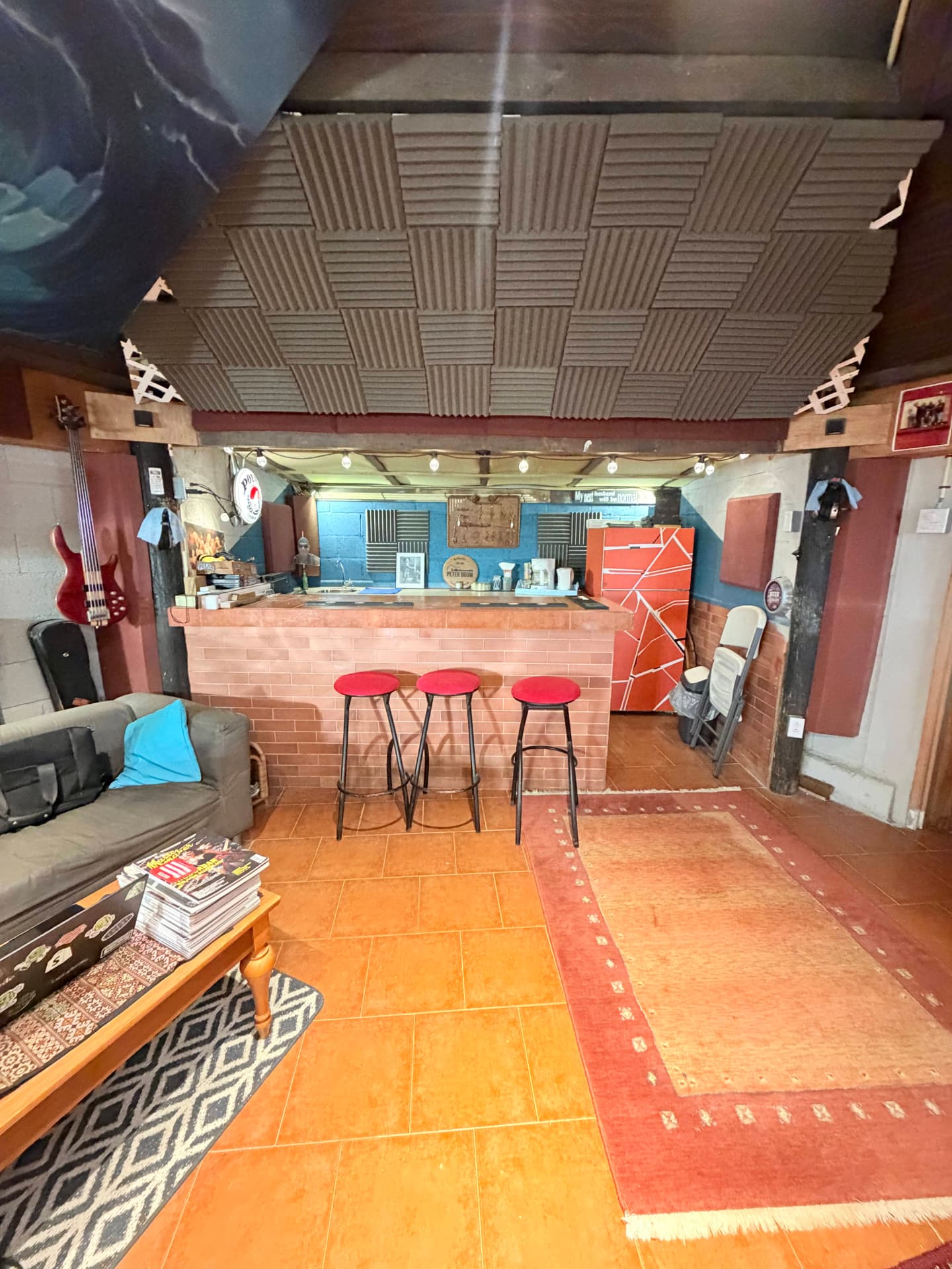 The studio lounge and bar area with red stools
