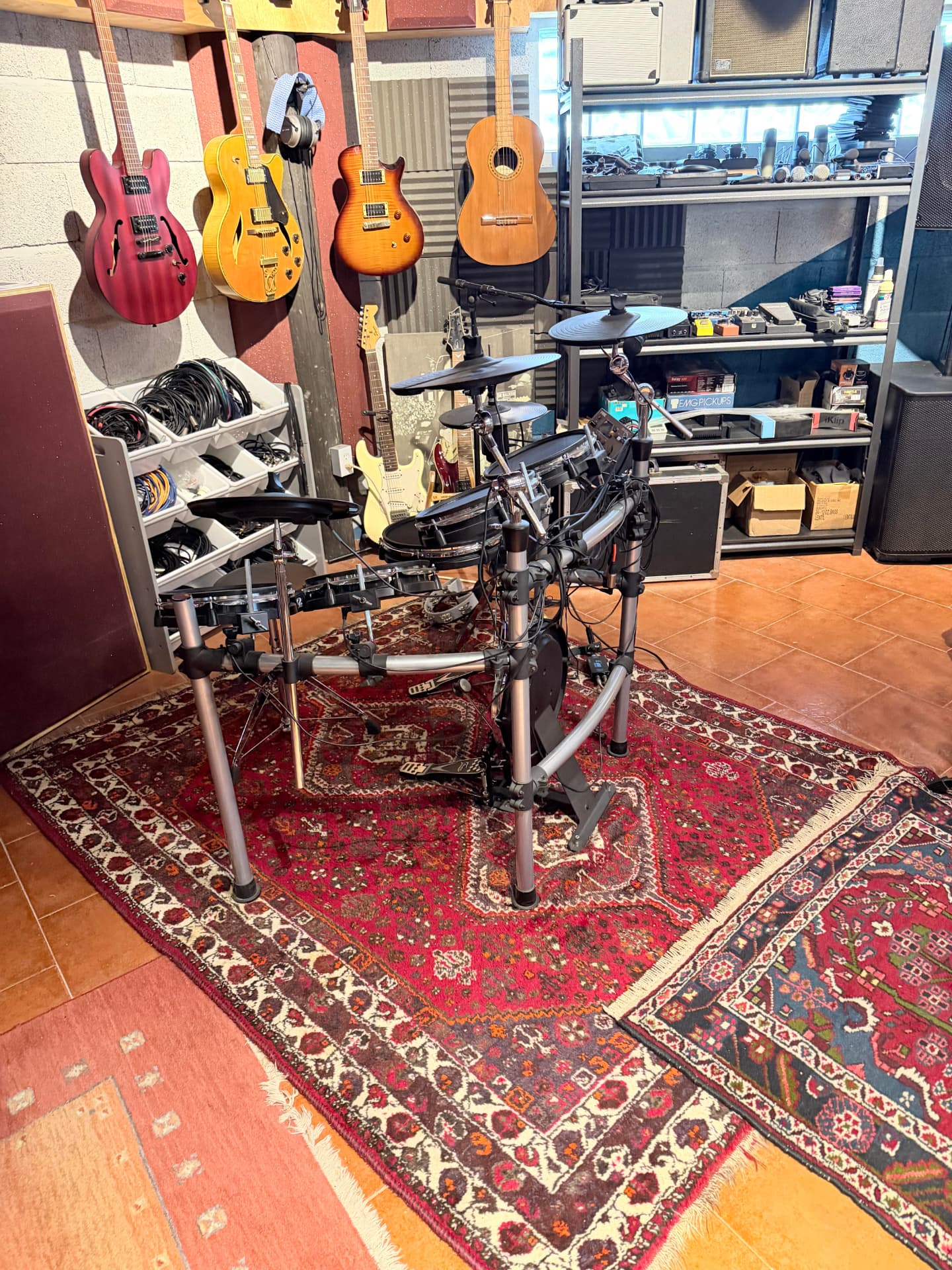 Electronic drum kit and guitar collection in the studio
